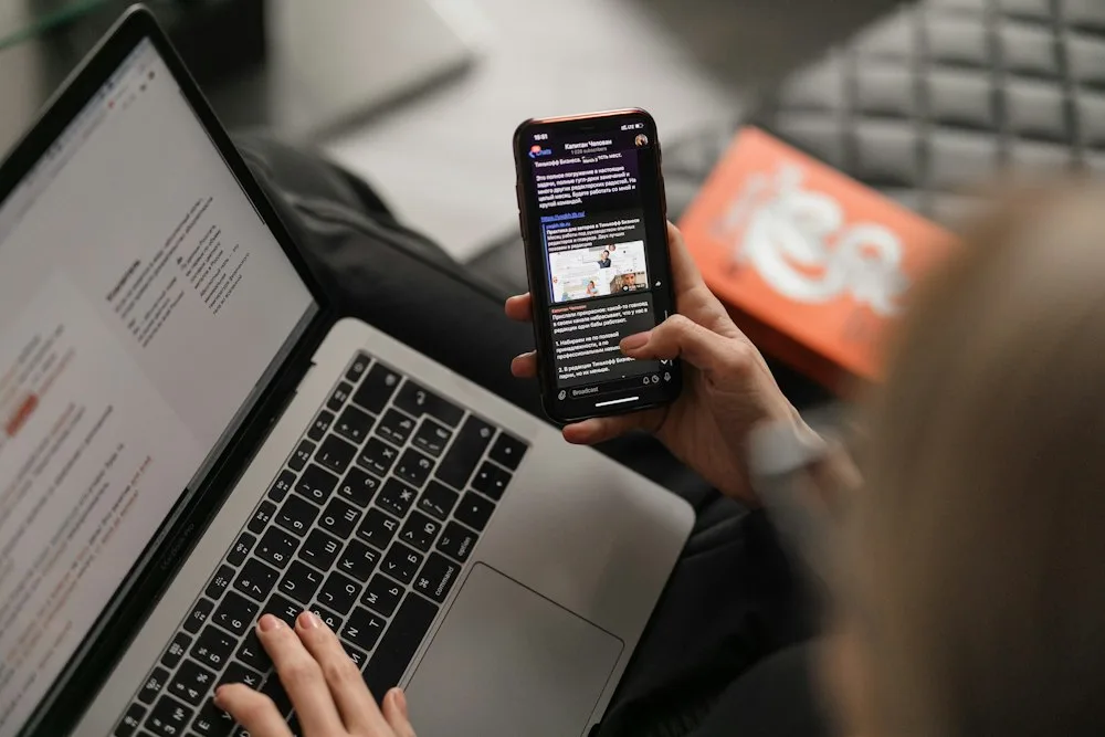 Smartphone resting upright on a clean minimalist desk stand for hands-free voice chanting