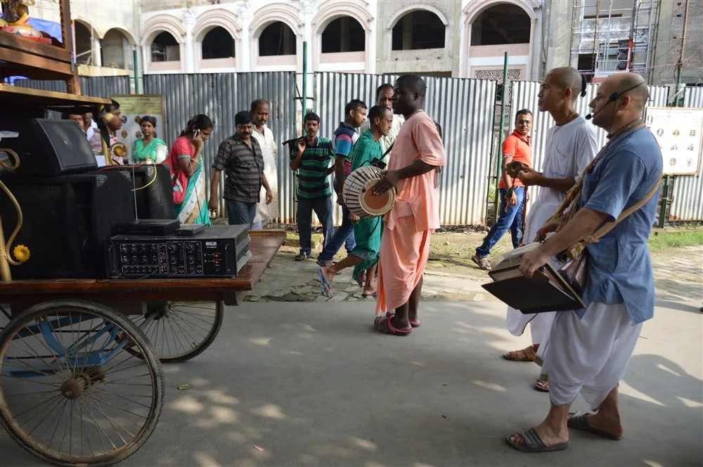 Indian devotees joyfully performing Harinam Sankirtan with traditional mridanga and kartals in Mayapur